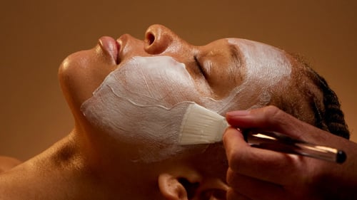 A woman is receiving a facial at Woodhouse Spa - Broomfield, CO location.