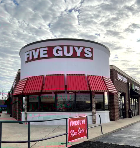 Exterior photograph of the Five Guys restaurant at 1401 S. Walton Boulevard in Bentonville, Arkansas.