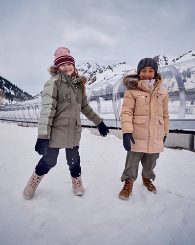 Two kids playing in the snow.