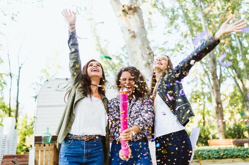 Three girls celebrating and cheering