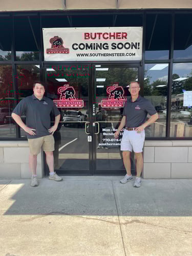 owner and manager in front of the shop