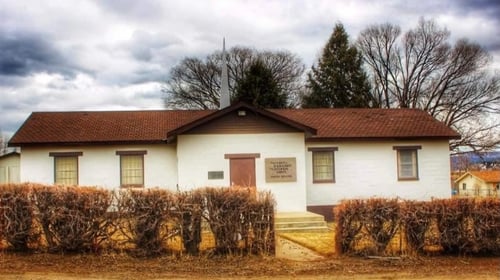 white brick building with brown roof