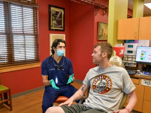 Dr. Keesh, Dentist in Tulsa talks to a patient about his dental health.