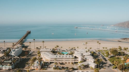 Oceanfront aerial view of Avila Beach House and Avila Beach located along the Central Coast in California.