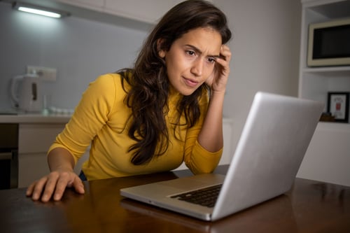 Woman looking at computer frustrated