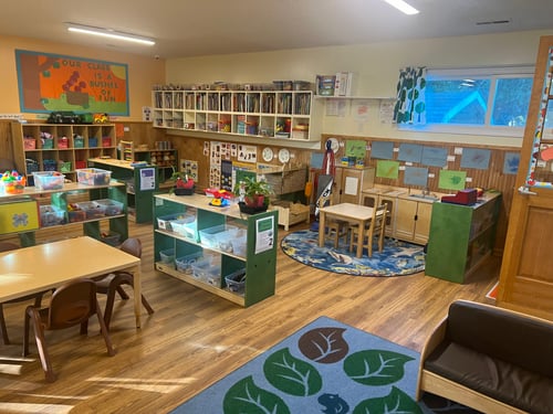 Bright, colorful Pre-K classroom filled with learning materials, art supplies, and play areas for growing minds.