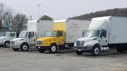 Various sized moving trucks parked next to each other