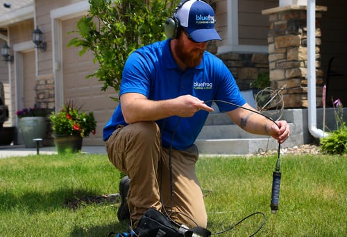 bluefrog plumber using leak detection equipment to locate an underground water leak