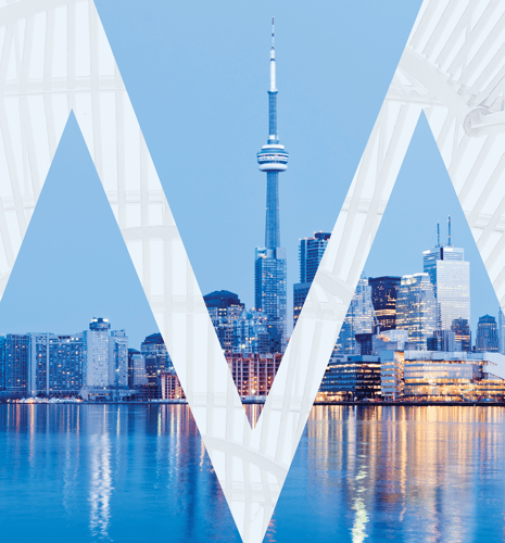 The Toronto city skyline in the evening with reflections in the water.