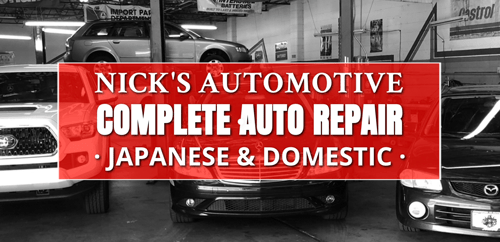 inside of shop with cars on lift