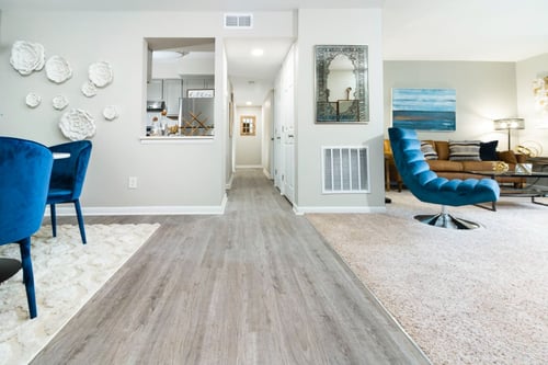 Living room, dining room, and hallway merge into a large open living space at The Woods of Fairfax Apartments, Lorton, VA 22079