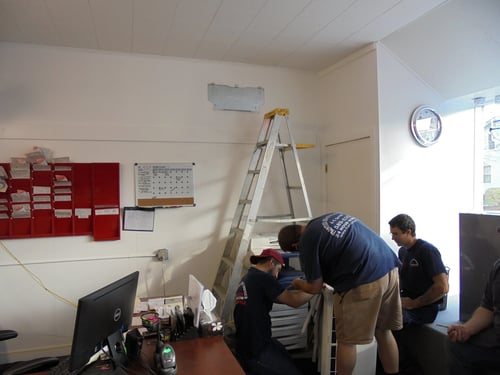Team prepping to install new ductless heat pump unit
