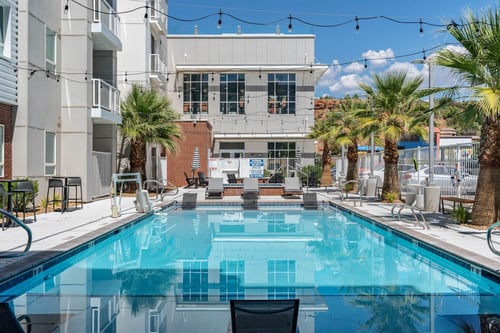 a swimming pool with a building in the background at 605 Place Student Housing & Co-Living, Utah, 84770