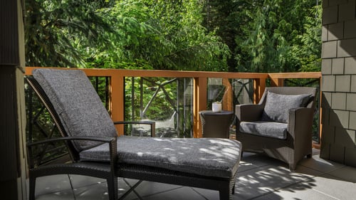 Luxury patio area with a cushioned deck chair at a luxury vacation rental in Whistler.