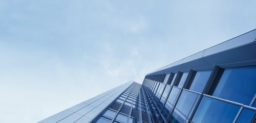 Bottom-up shot of a large scaling Toronto building representing growth, strength, and investment discipline