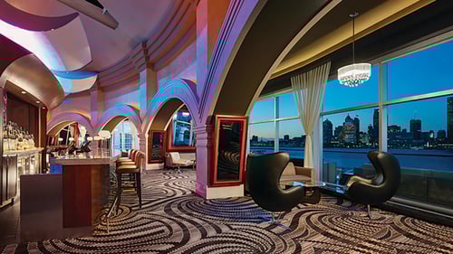 Sunset at VU Bar, floor‑to‑ceiling windows and Detroit skyline, Riverside Dr E Caesars Windsor