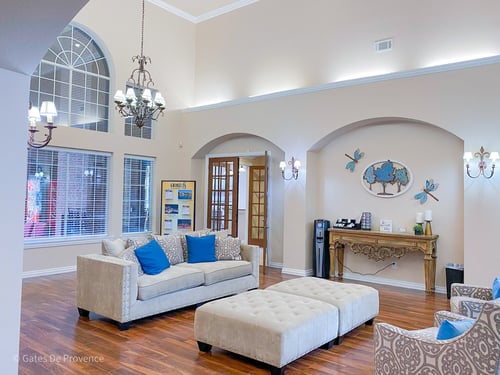 Clubhouse living room with white couches at Gates de Provence community clubhouse offers chairs to lounge and hang out in at Gates de Provence Apartments, Dallas, TX, 75287