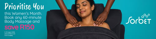 A woman with her eyes closed relaxes during a shoulder massage while a therapist's hands massage her neck and shoulders.