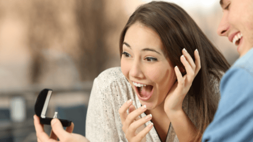 man and woman looking at an engagement ring