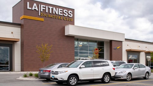 White and silver cars parked in front of LA Fitness