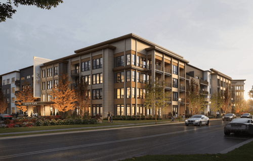 A modern apartment building with cars parked in front.