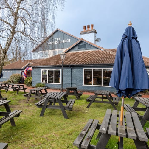Outdoor seating area with benches at The Tappers Harker