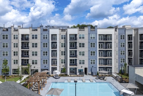 A large apartment complex with a pool in the courtyard at The Collective Upper Westside Apartments, Georgia