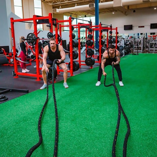 Intense battle rope workout at a functional fitness space in one of the best nearby gyms.