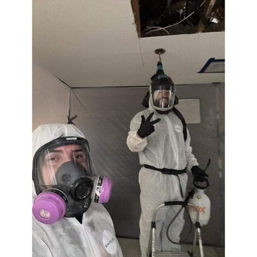 Restoration 1 technicians are finishing up a roof leak remediation.