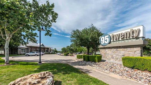 A sign that says 95 Twenty in front of a building.