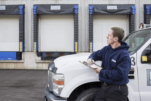 Lenworth Team member outside of the vehicle truck starting inspection on docks and garages