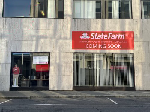 Brick building with red State Farm sign