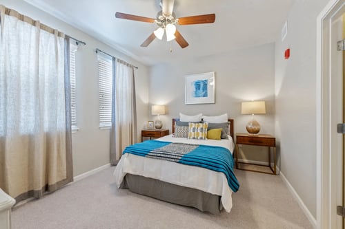 Bedroom at The Sanctuary at 331 Apartments with soft carpeting and large window.