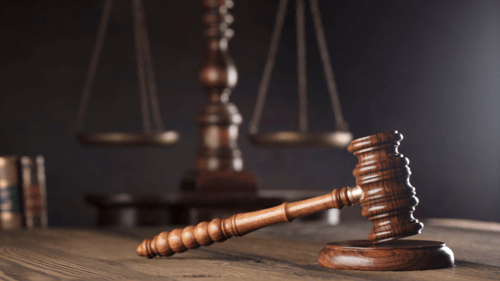 gavel on a table with scale of justice