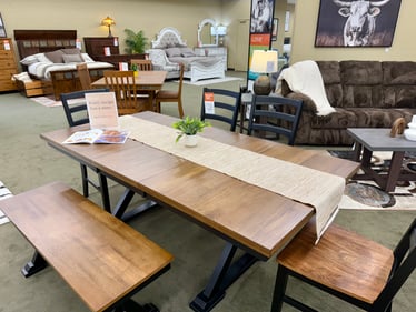 Wood and metal dining table with bench seating display at Slumberland Furniture Burlington. Shop modern farmhouse dining room furniture in Burlington, Iowa.