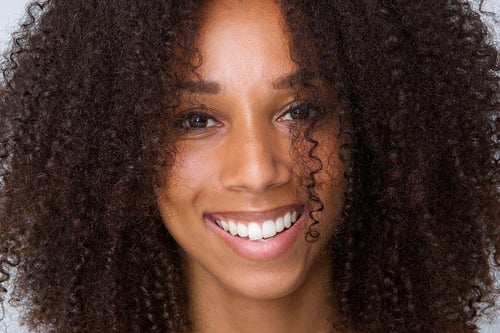curly-haired woman smiling
