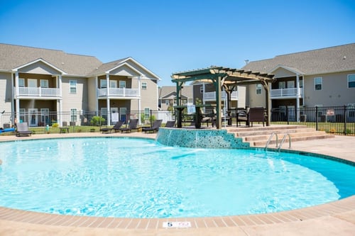 Resort style swimming pool with waterfall feature at The Lory of Greenway Village Apartments, Kentucky