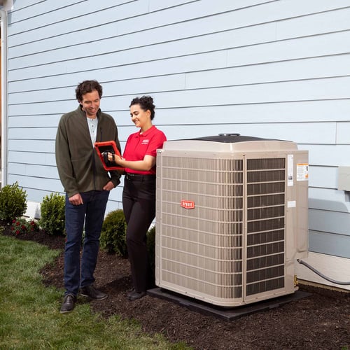 Bryant dealer talking to a homeowner after heat pump installation.