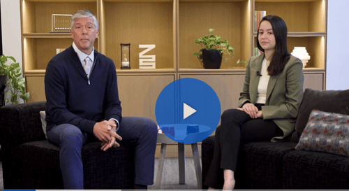 Man and woman sitting across from each other facing the camera