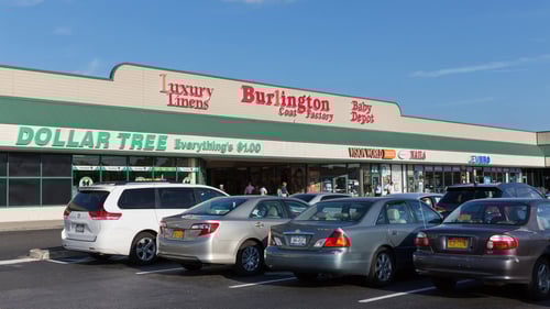Parked cars lined up in parking lot in front of Dollar Tree and Burlington
