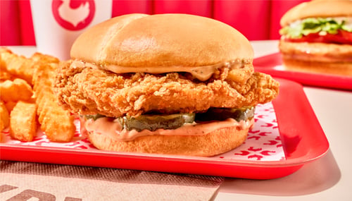 Zaxbys signature chicken sandwich served with crinkle fries and a drink.