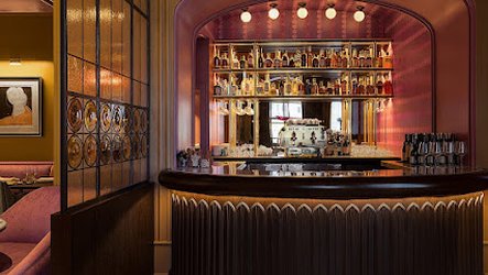 Luxury restaurant interior with a symmetrical layout, featuring art deco-inspired design, round chandeliers, circular panel details and checkered flooring