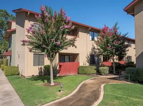 Exterior building with landscaping and pathways at Lodi Commons Senior Living, Lodi, CA
