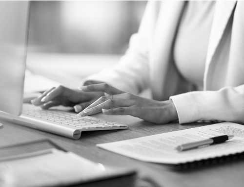 Close up of a business woman typing on a keyboard.