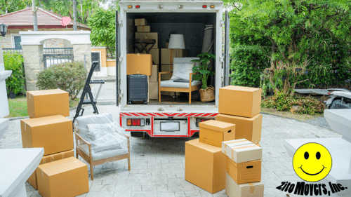 packed moving truck with boxes sitting outside of it