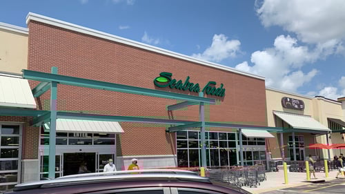 People and shopping carts in front of Seabra Foods