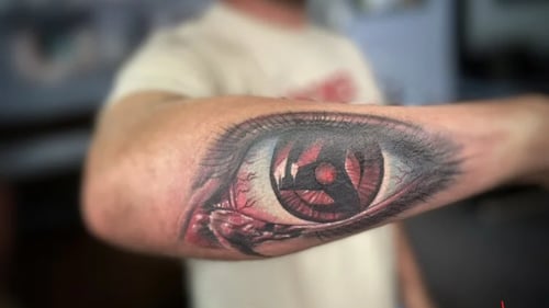 Tattoo of an eye on a persons forearm