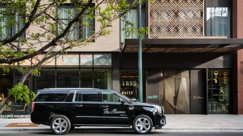 Exterior of The Maven Hotel and house car.