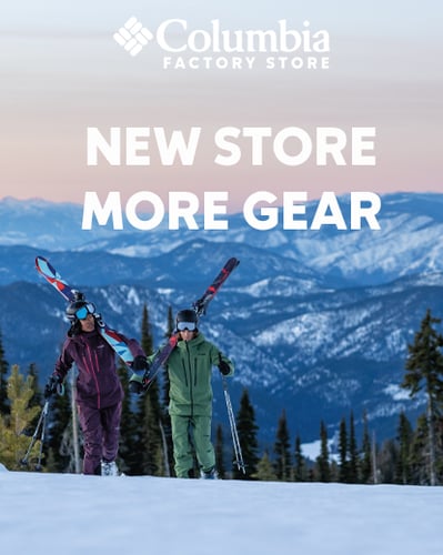 Two people walking with skis.