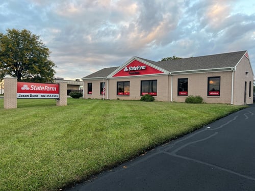 Brick building with red and white State Farm sign out front